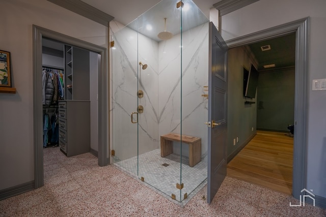 bathroom with a shower with door