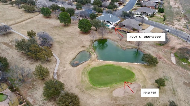 bird's eye view with view of golf course, a water view, and a residential view