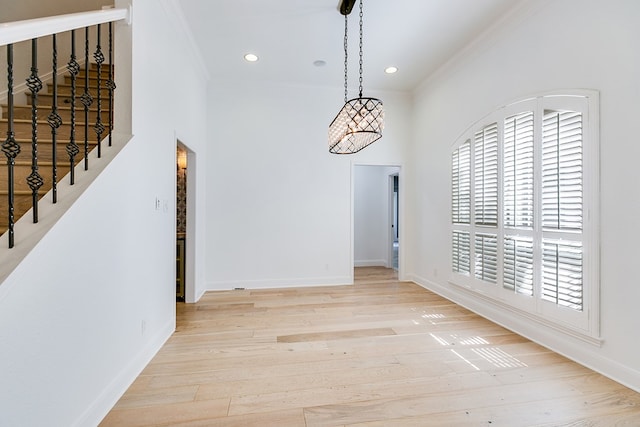 unfurnished dining area featuring wood finished floors, baseboards, recessed lighting, and ornamental molding