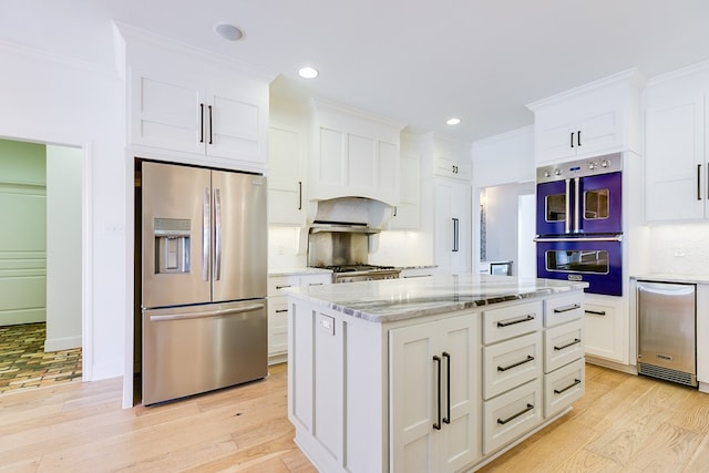 kitchen with decorative backsplash, stainless steel refrigerator with ice dispenser, light wood-style floors, and white cabinets