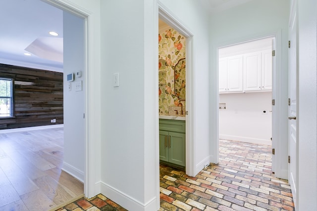 hall featuring recessed lighting, crown molding, baseboards, and a tray ceiling