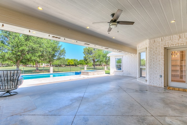 view of patio featuring a ceiling fan, a pool with connected hot tub, and a fenced backyard