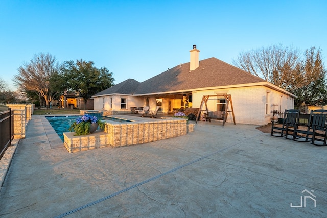 view of swimming pool with fence, a patio area, and a fenced in pool