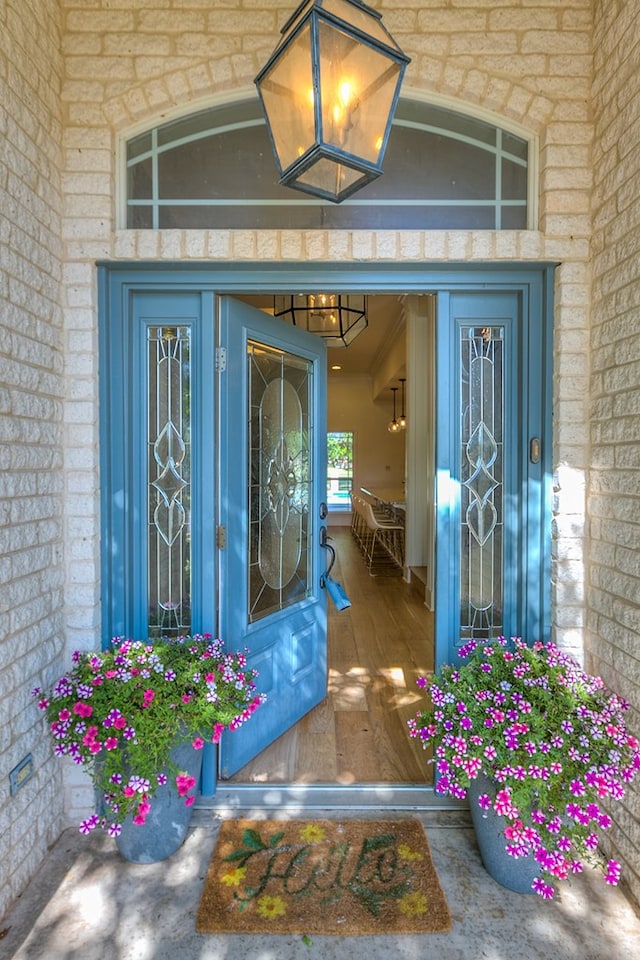 view of exterior entry with brick siding