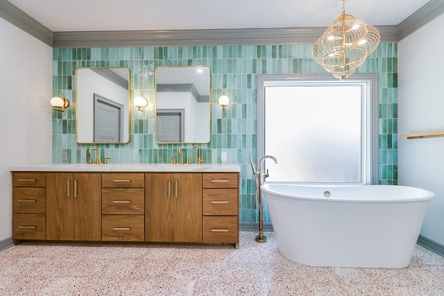 full bathroom with speckled floor, an inviting chandelier, crown molding, and double vanity