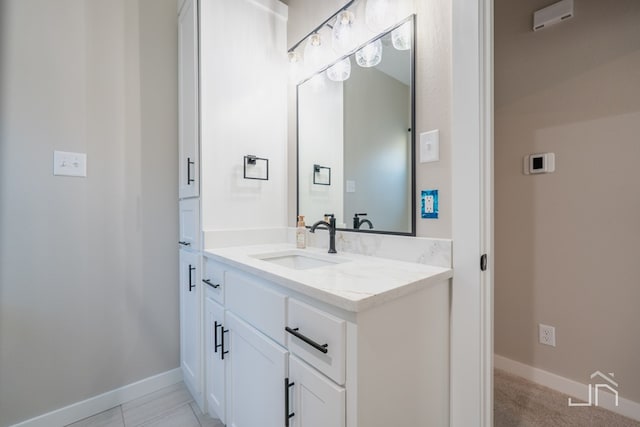 bathroom with vanity and baseboards