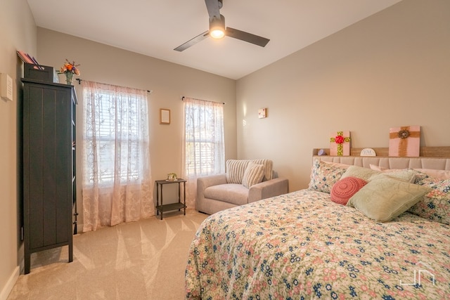 bedroom with light carpet, lofted ceiling, and ceiling fan