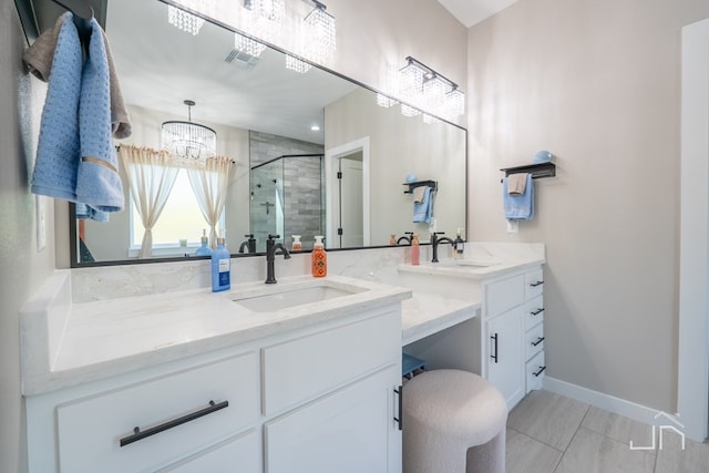bathroom featuring a notable chandelier, vanity, baseboards, a shower stall, and visible vents