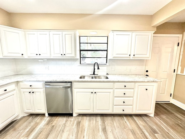 kitchen featuring sink, white cabinets, and dishwasher