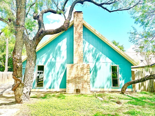 view of side of property with a yard