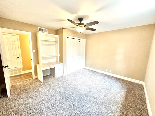 unfurnished bedroom with carpet flooring, ceiling fan, and a closet