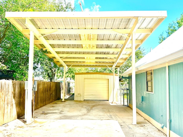 view of patio / terrace with a garage and an outdoor structure