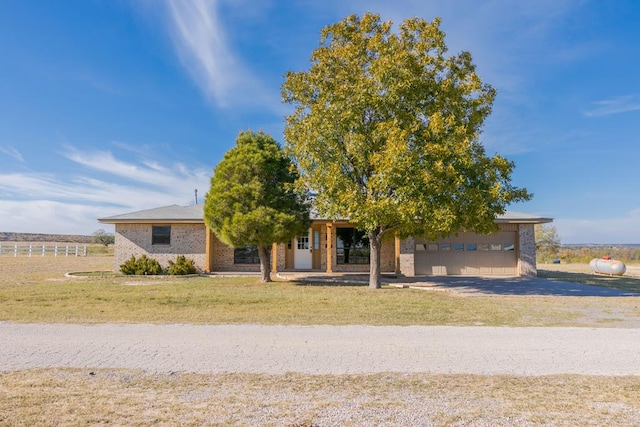 view of front of property featuring a garage and a front lawn