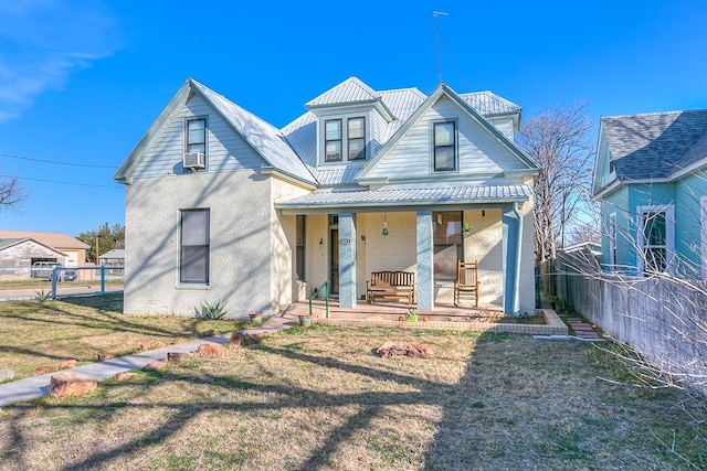 rear view of property with metal roof, a porch, cooling unit, fence, and a yard