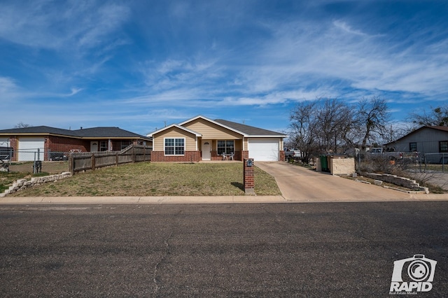 ranch-style house with driveway, fence, a front yard, a garage, and brick siding