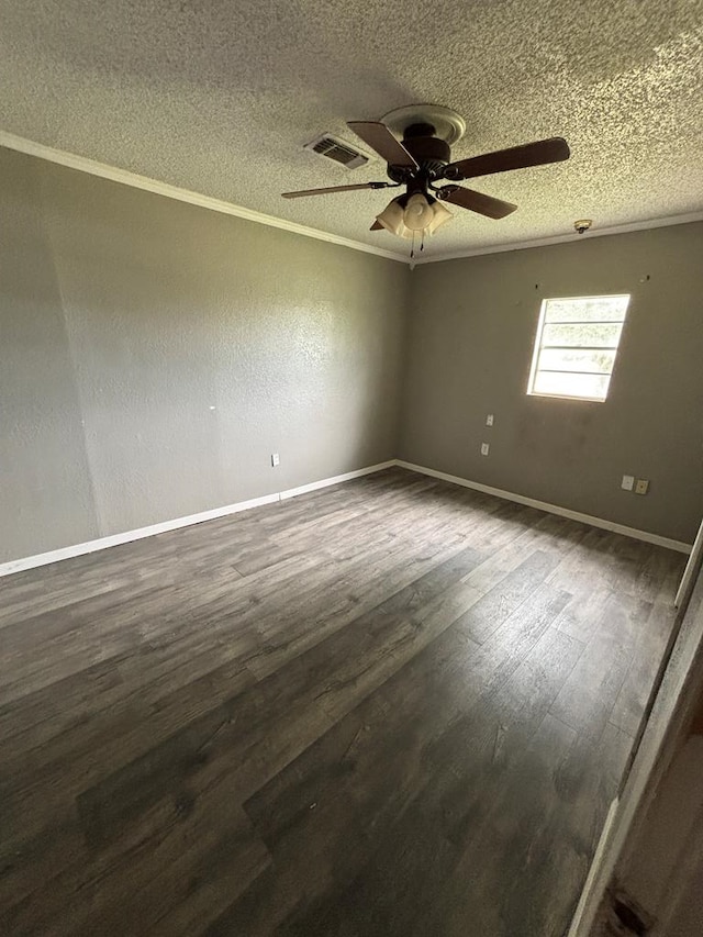 7646 Violet St, San Angelo, TX 76901 - spare room featuring a textured ceiling, dark wood-style floors, a ceiling fan, baseboards, and ornamental molding