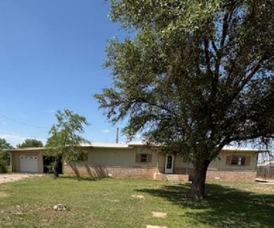 7646 Violet St, San Angelo, TX 76901 - view of front facade featuring a front yard and an attached garage