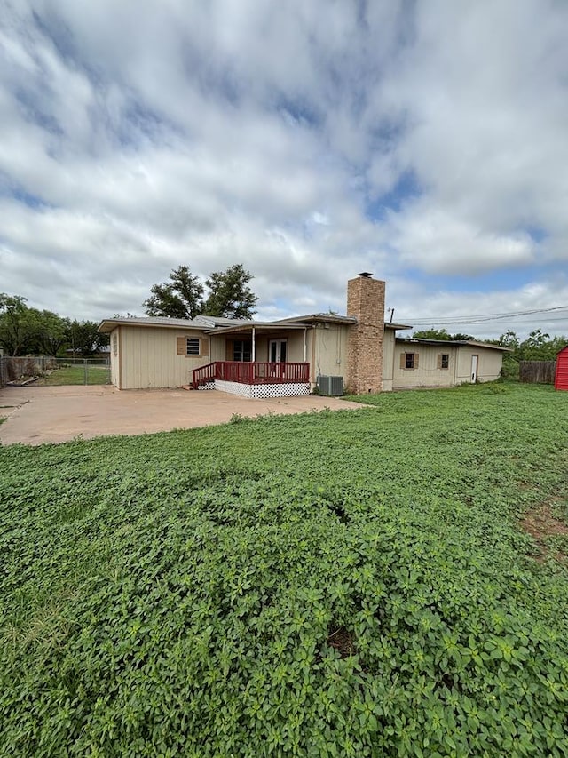 7646 Violet St, San Angelo, TX 76901 - back of house with cooling unit and a chimney