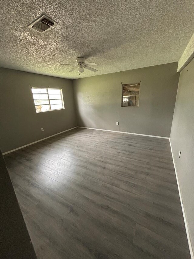 7646 Violet St, San Angelo, TX 76901 - unfurnished room featuring ceiling fan, wood finished floors, a textured ceiling, and baseboards
