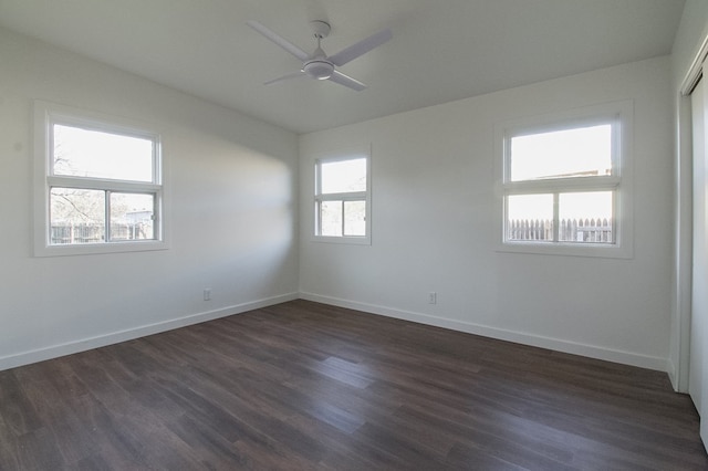 spare room featuring dark wood-type flooring, ceiling fan, and vaulted ceiling