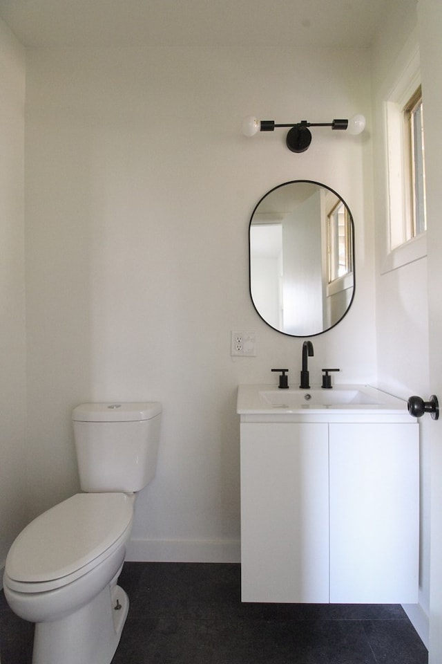 bathroom featuring vanity and toilet