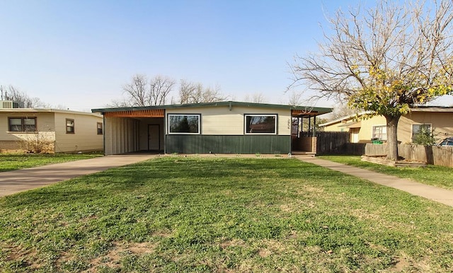 view of front facade with a carport and a front yard