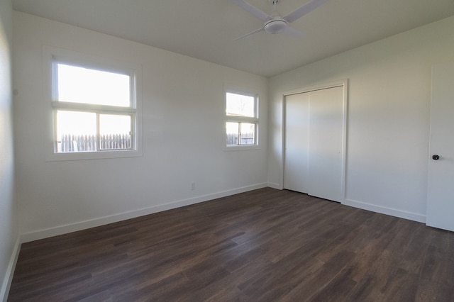 unfurnished bedroom with ceiling fan, dark hardwood / wood-style flooring, vaulted ceiling, and a closet