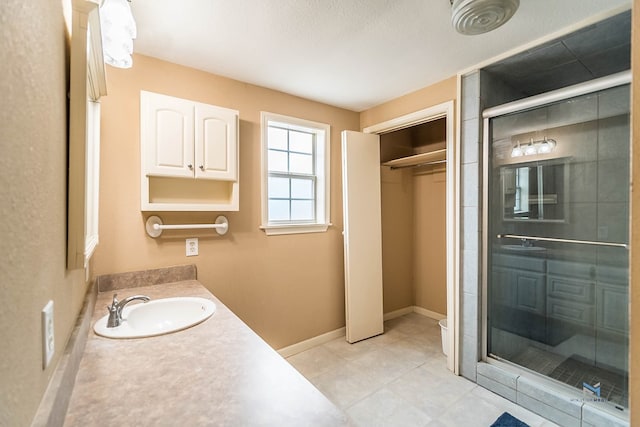 bathroom featuring vanity and a shower with door