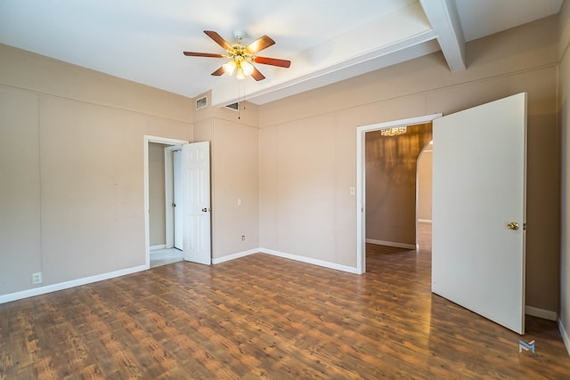 spare room with dark hardwood / wood-style flooring, beam ceiling, and ceiling fan