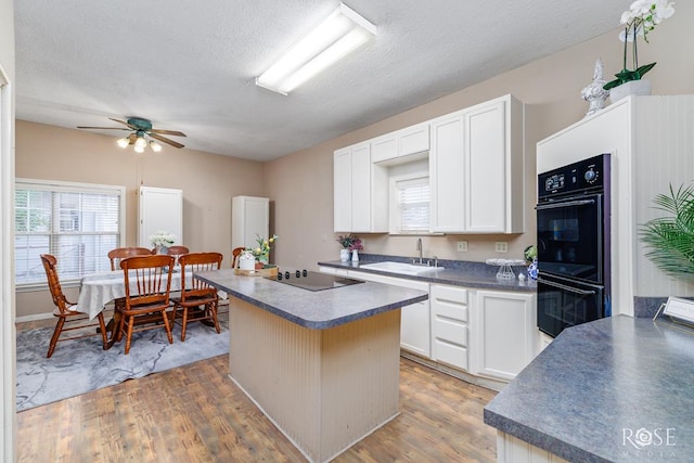 901 Koberlin St, San Angelo, TX 76903 - kitchen featuring black appliances, dark countertops, a sink, a kitchen island, and ceiling fan