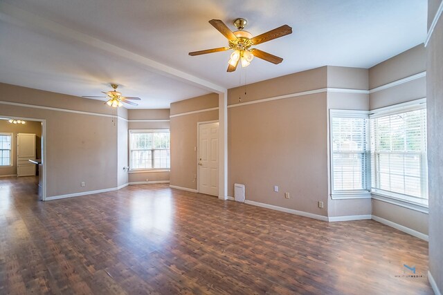 spare room with ceiling fan, plenty of natural light, and dark hardwood / wood-style flooring