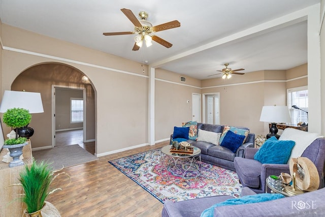 901 Koberlin St, San Angelo, TX 76903 - living area featuring a ceiling fan, arched walkways, wood finished floors, and baseboards