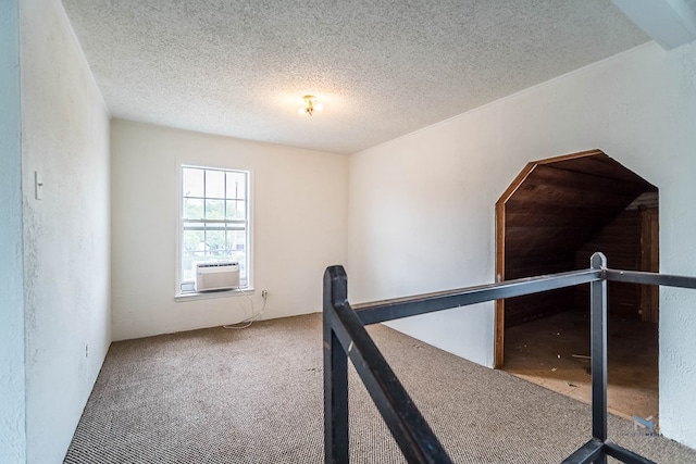 interior space with cooling unit, a textured ceiling, and carpet flooring