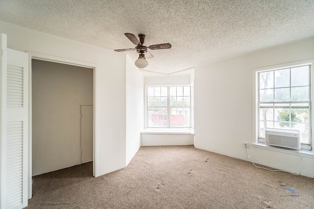 unfurnished bedroom with multiple windows, a textured ceiling, a closet, and ceiling fan