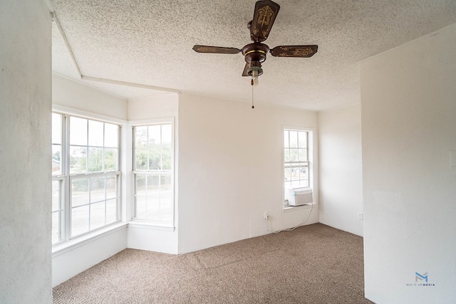 unfurnished room with a healthy amount of sunlight, ceiling fan, a textured ceiling, and carpet flooring