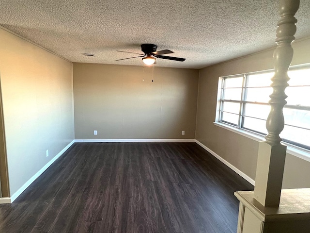 unfurnished room featuring ceiling fan, dark hardwood / wood-style floors, and a textured ceiling