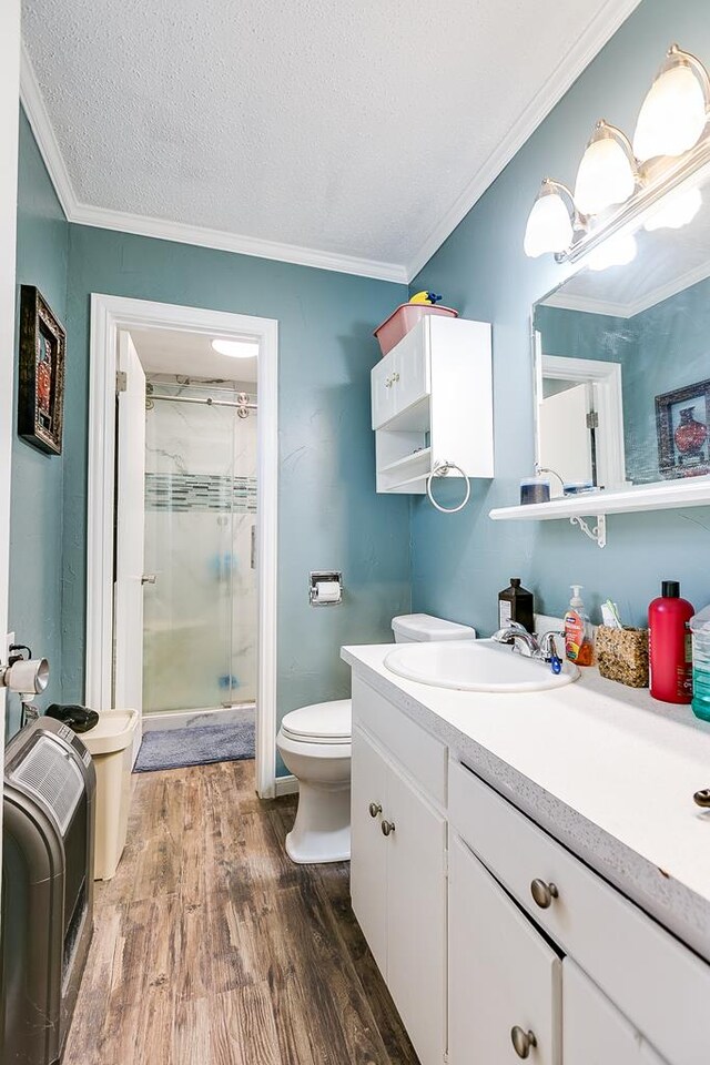 bathroom featuring toilet, an enclosed shower, a textured ceiling, vanity, and hardwood / wood-style flooring