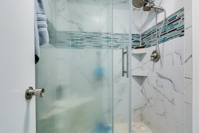 bathroom with a shower with door