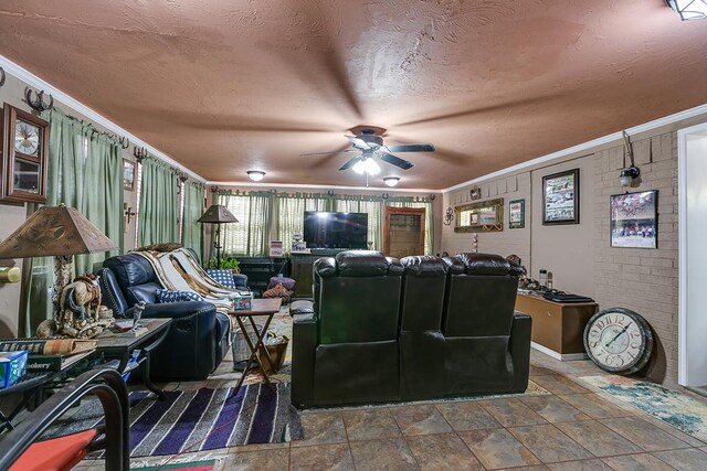 home theater room featuring crown molding, ceiling fan, brick wall, and a textured ceiling