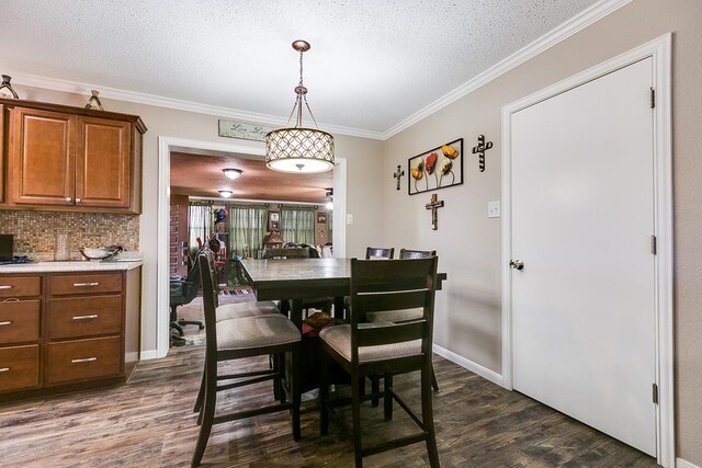 dining area featuring crown molding, dark hardwood / wood-style floors, and a textured ceiling