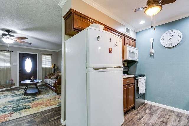 kitchen with ceiling fan, white appliances, ornamental molding, and dark hardwood / wood-style flooring