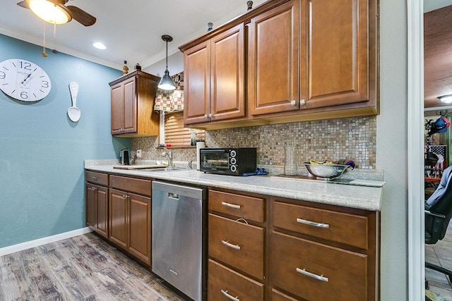 kitchen featuring hardwood / wood-style flooring, dishwasher, hanging light fixtures, ornamental molding, and decorative backsplash