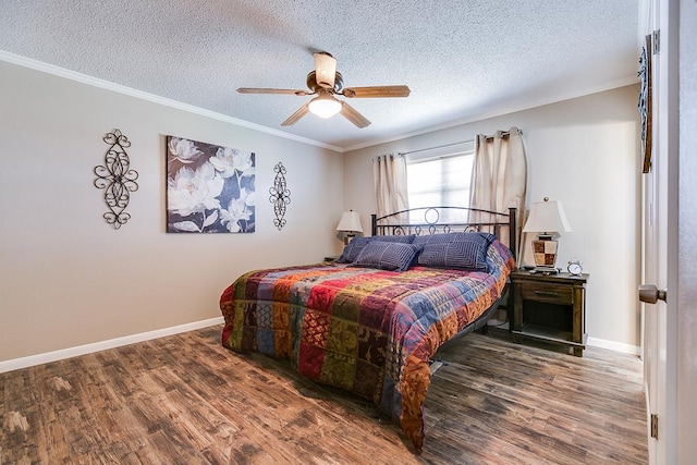 bedroom featuring crown molding, dark wood-type flooring, a textured ceiling, and ceiling fan