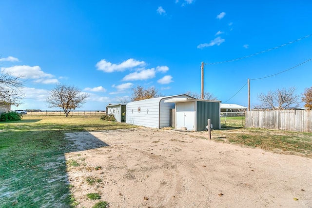 view of yard featuring a carport and a shed