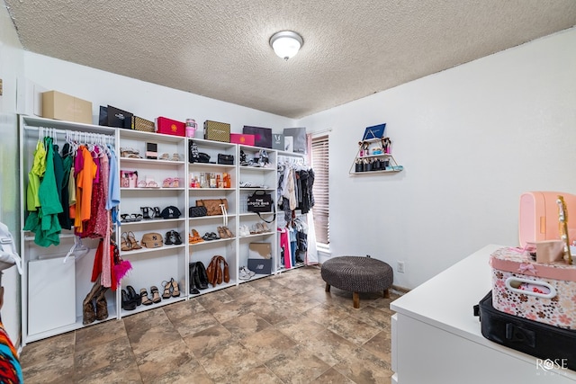 spacious closet with stone finish flooring