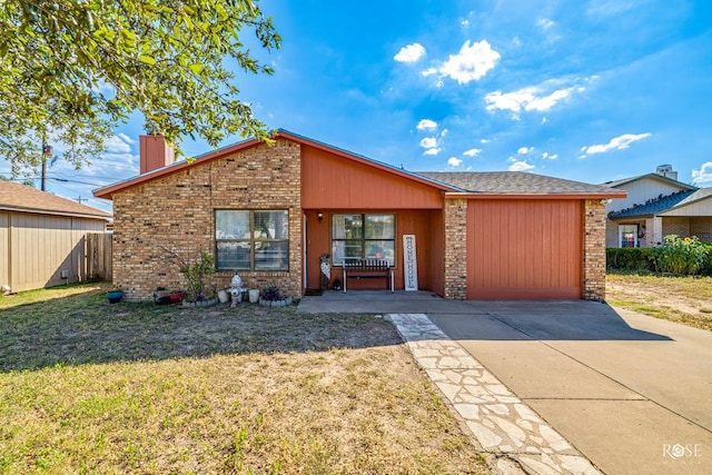 mid-century inspired home featuring concrete driveway, brick siding, a chimney, and a front lawn