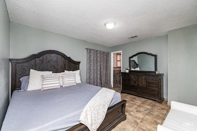 bedroom featuring visible vents and a textured ceiling