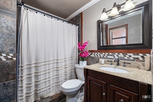 full bath featuring toilet, ornamental molding, a textured ceiling, vanity, and tile walls