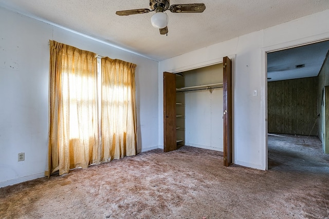 unfurnished bedroom with ceiling fan, carpet flooring, a closet, and a textured ceiling