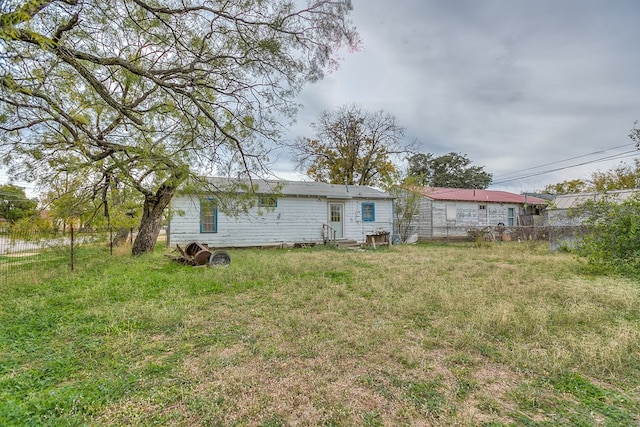 back of house with a lawn